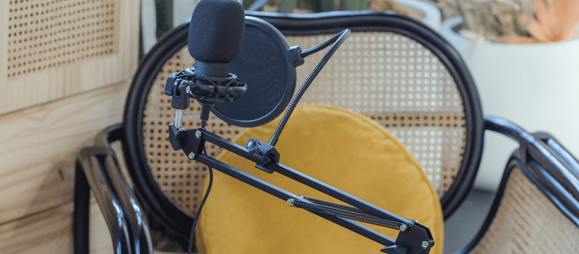 microphone with yellow chair in the background. this article is about how to get into voice acting.